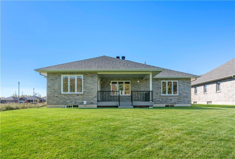 Rear view of the home and yard