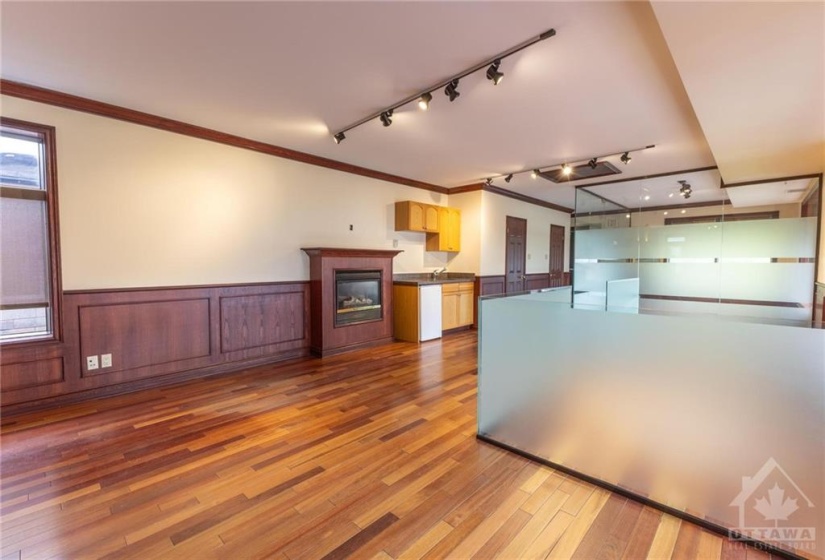 Open area overlooking gas fireplace and kitchenette