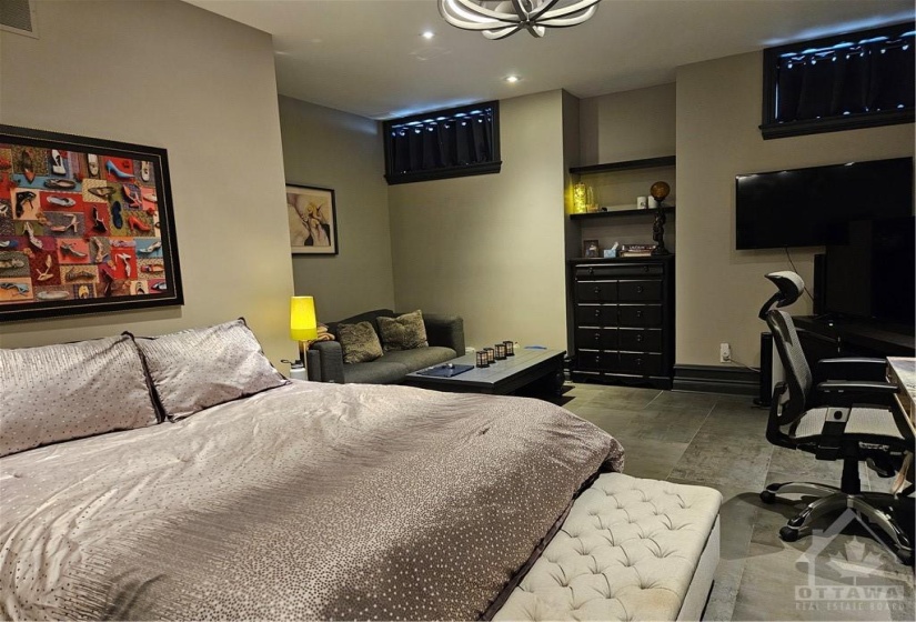 The lower level includes this bedroom with its own ensuite bath, big enough for a TV and loveseat and a desk. The ideal multi-generational space or as a caregiver suite.