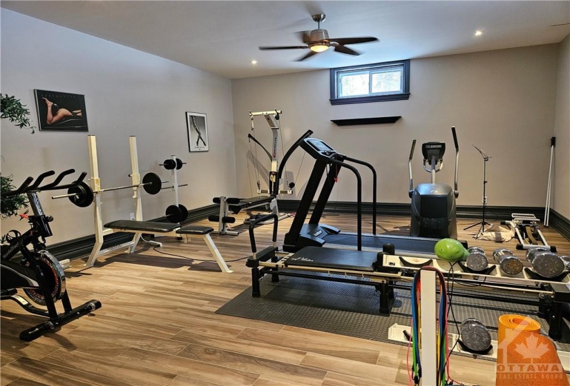 No need to buy a gym membership when you can have this area for your own home gym. It is bright with windows on two sides.