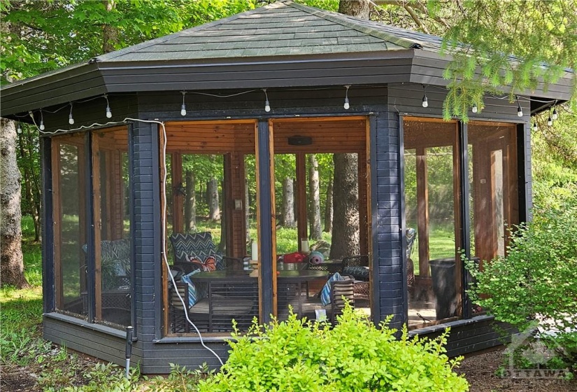 This octagonal custom cedar gazebo is the go to place in the evening it also has speakers built in a ceiling fan to move the humid summer air and screens to keep the bugs at bay. There are also custom covers for the screen panels in the winter.