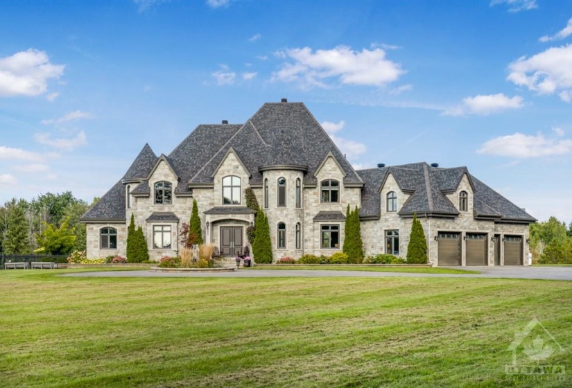 All stone exterior with large 4 car garage