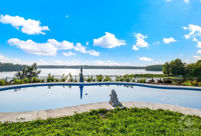Relax in the 2021 inground heated pool with panoramic lake views