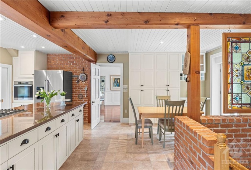Wooden beams and red brick walls enhance this cosy kitchen