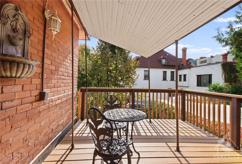 Rear partially covered terrace/balcony overlooks rear yard.  Perfect for those quiet reading hours.