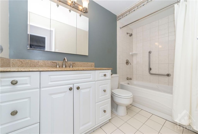 Beautifully updated bathroom including large vanity with granite counter