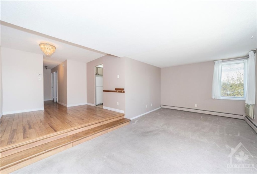 Step down to expansive living room with plenty of space for a piano, home office etc.