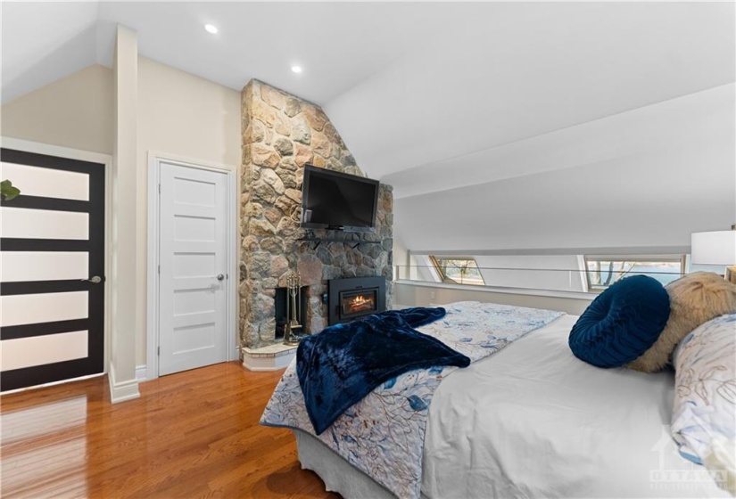 You can see the property has upgraded every door to add that modern feel.  Wood burning fireplace for those romantic evenings.  Beautiful skylights with remote controls overlooking the river.  This fireplace has never been used.  Please note:  A fire has been virtually staged into the fireplace.