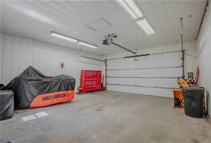 Garage walls covered in white tin, brightens the space and makes it very functional for many uses.