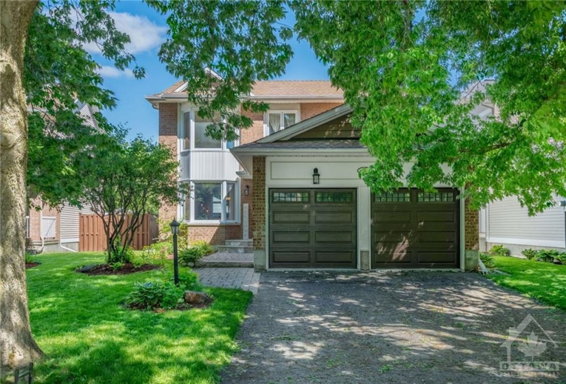 Mature trees welcome you to a long laneway with ample parking.
