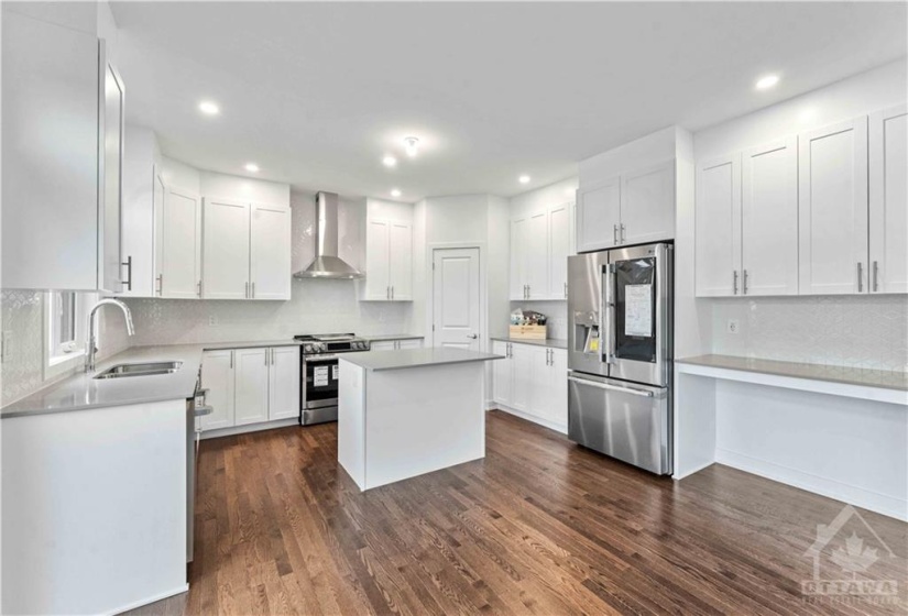 Kitchen has a desk area and comes with quartz counters and all brand new stainless appliances
