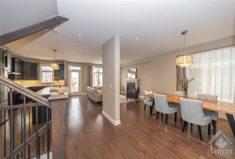 Elegant open-concept living, with hardwood flooring, smooth ceilings, strategic pot lights, and upgraded lighting fixtures makes for a seamless blend of comfort and function.