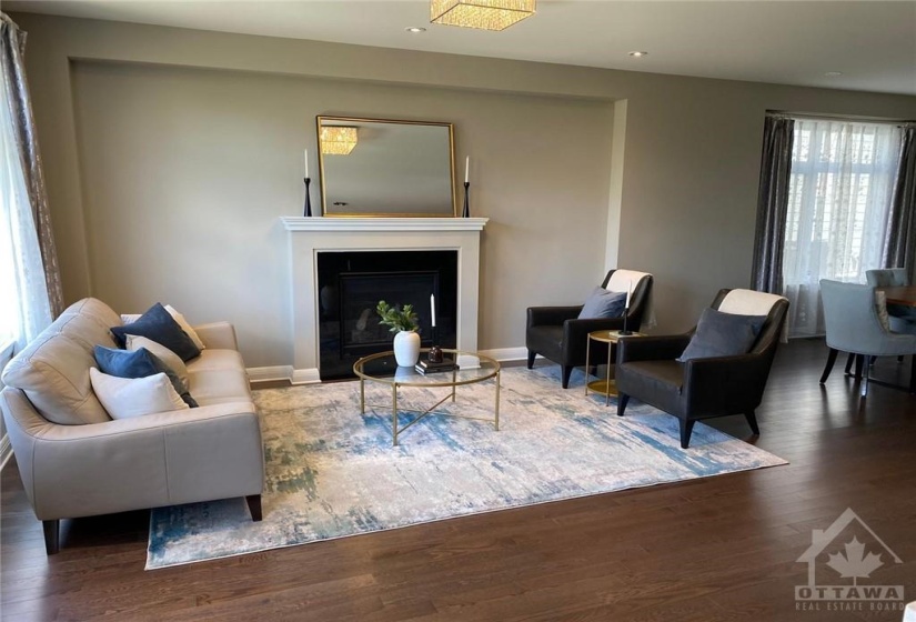 Enjoy relaxing with loved ones in the living room with gas fireplace and large windows