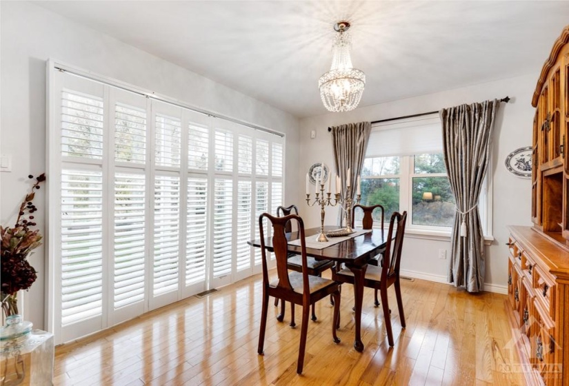 Formal dining room wall of patios doors with built-in California shutters