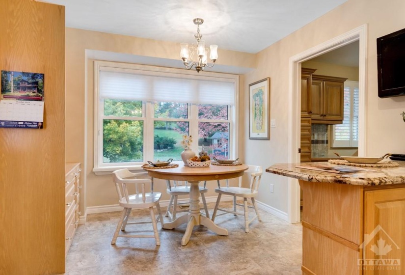 Sun-filled dinette has door to large back deck