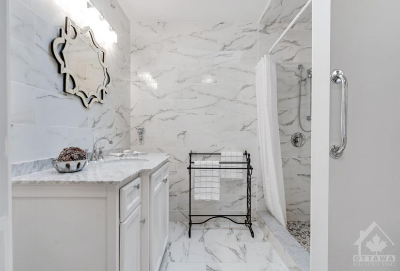 Luxury ensuite has marble vanity and ceramic shower