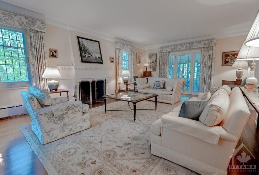 Formal living room with gas fireplace & sunroom access.