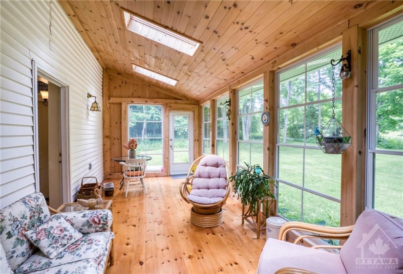 Sunroom with floor to ceiling windows And skylights