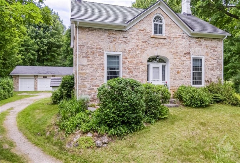 Classic stone home with three car detached garage on acreage