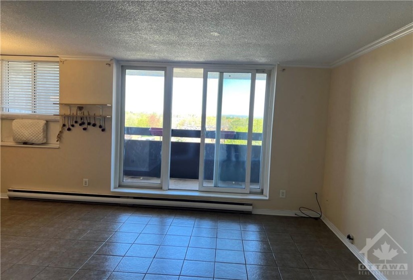 Large walk out windows floods unit with natural light and leads to beautiful balcony