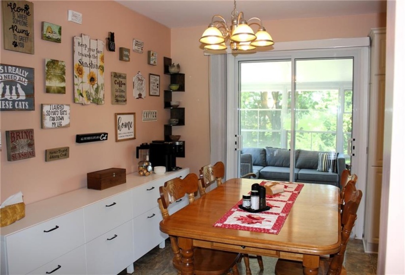 Dining area with patio doors to sunroom