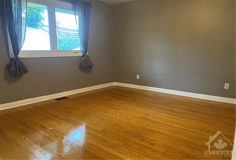 primary bedroom with hardwood flooring