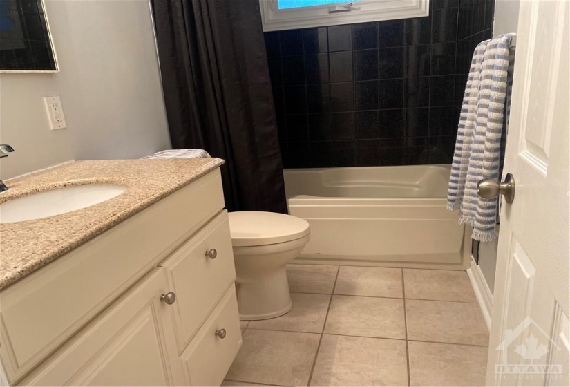 bathroom, soaker tub, vanity with granite counter & ceramic flooring