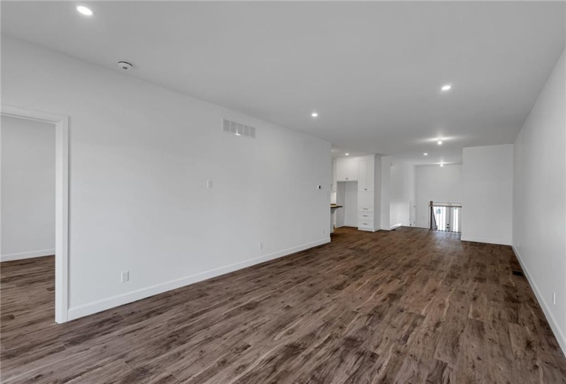 View from living room area showing entrance into primary bedroom.