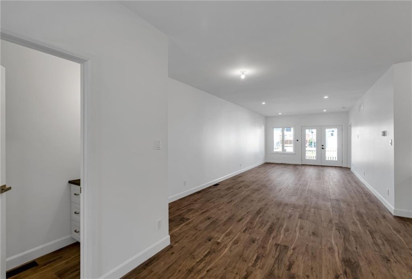 View of main level showing 2pc powder room and patio doors to rear deck.