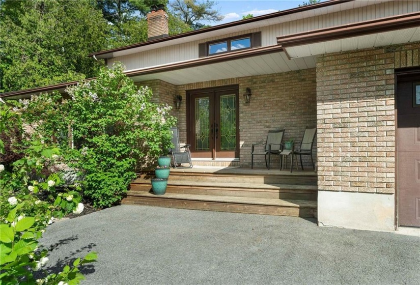 Covered entry. French doors to large foyer.