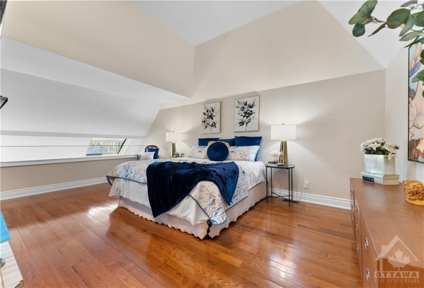 Primary bedroom.  This bed is a king size bed to give you the scale.  Beautiful vaulted ceiling above the bed.