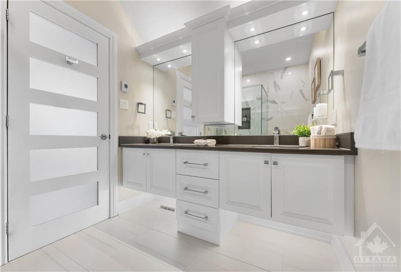 This gorgeous white bathroom has been beautifully renovated to a spa like oasis with a double vanity, plenty of counterspace, walk in shower with an amazing shower with jets everywhere and a waterfall.  Complete high end package... even the toilet is high end.