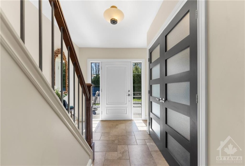 Large foyer with double closet.. oversized front door and a powder room immediately on the left as you walk in.