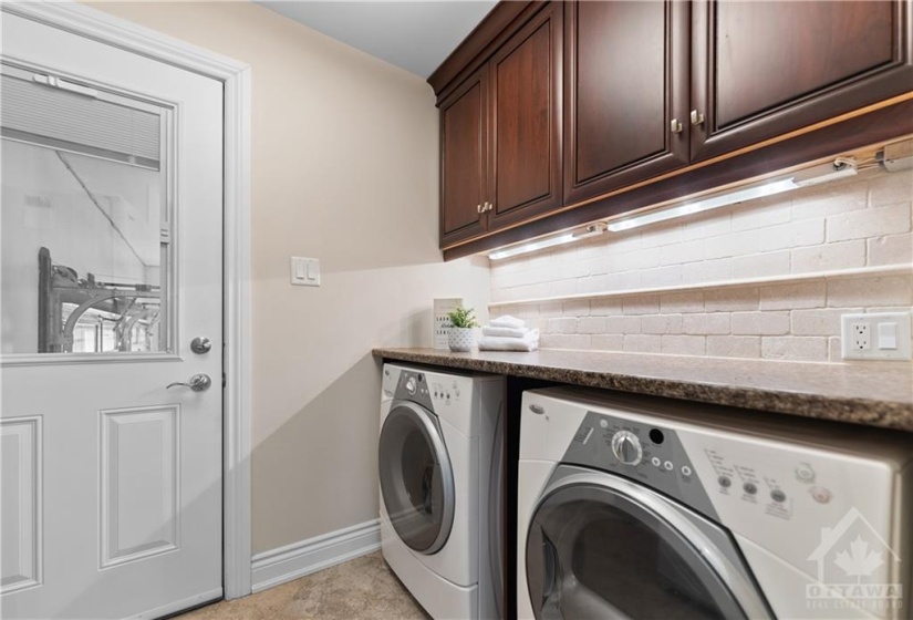 Beautiful main floor laundry room just inside the entry from the garage and before you enter into the kitchen.