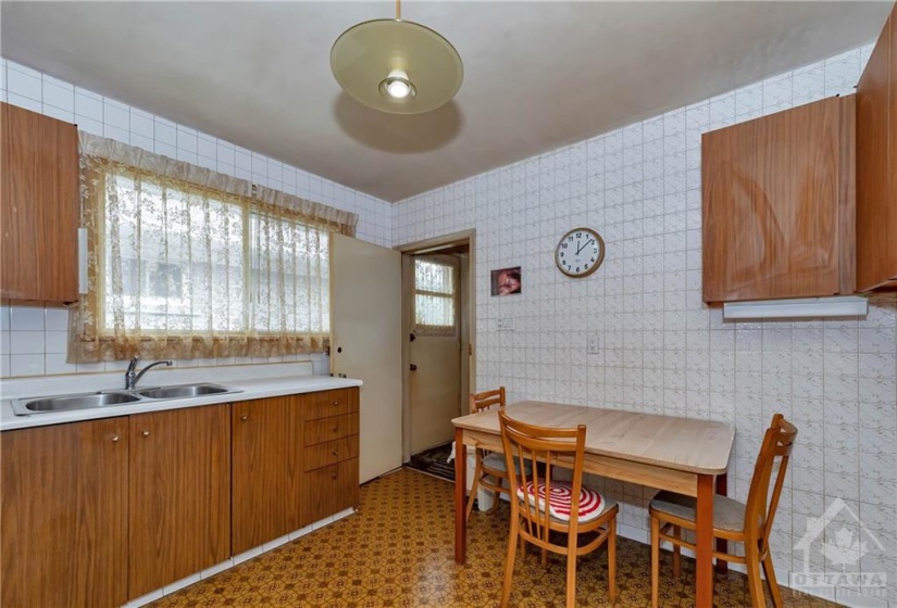 Cute eat in kitchen. Back door leading straight down to the basement.