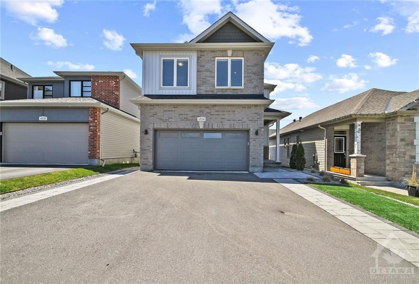 Oversized double laneway with interlock border and synthetic turf