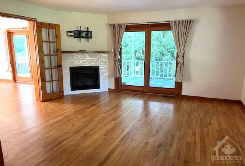 Living Room with fireplace and access to large deck