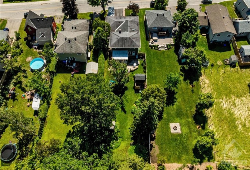 Trees line the back and side perimeter of this yard creating great privacy year round (evergreens in the back)