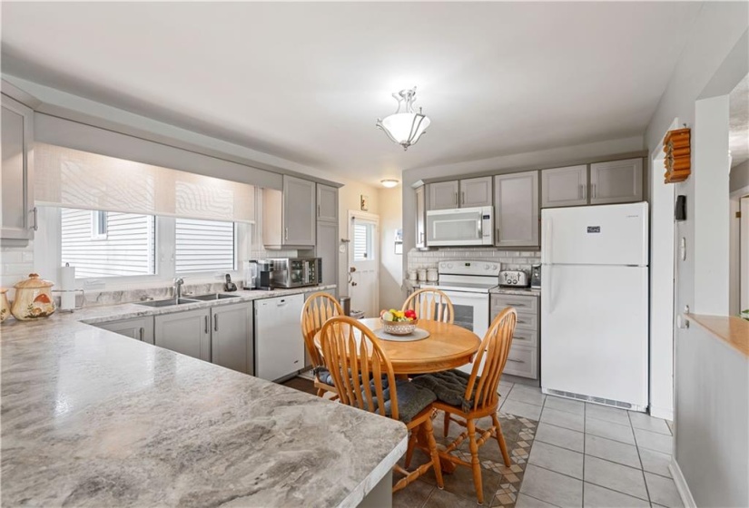 Kitchen opens/overloooks the living room and dining room areas.