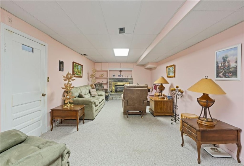 Additional view of the rec room/family room warmed by a gas fireplace.