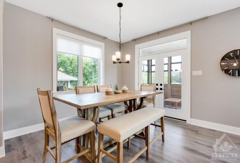 Dining area garden door opens to three-season sunroom