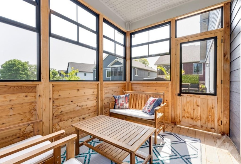 Relaxing sunroom for lounging and has door to upper deck