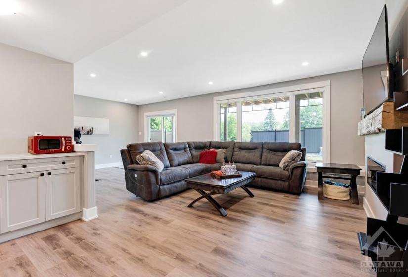 Lower level family room (or in-law suite living room) has second electric fireplace with touch screen and colour light flame