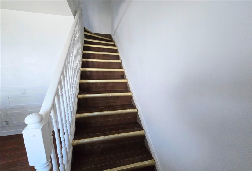 The stairway to the three bedrooms upstairs and main washroom.