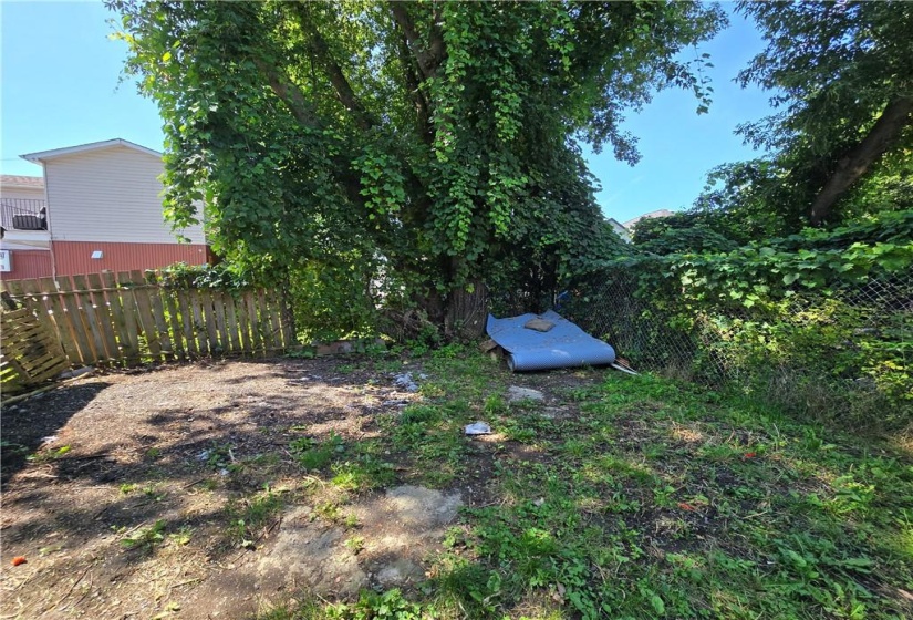 There is parking space in the back for two cars as well as driveway parking. This photo shows the vacant side. There is a more space behind the tenanted side which is currently used as  garden.