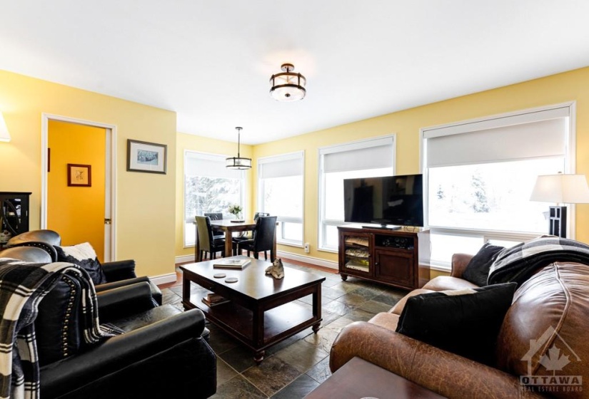 Familyroom slate floor, dinette and windows with spectacular country view - plus custom black-out blinds