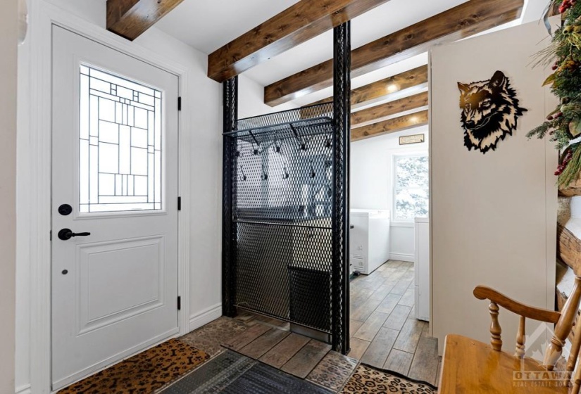 Inviting foyer porcelain floor that extends into attached laundry room