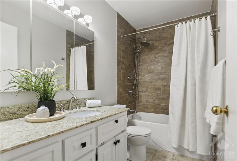 Main bath updated with tile floors, tub with tile walls, granite countertop and new light fixture.