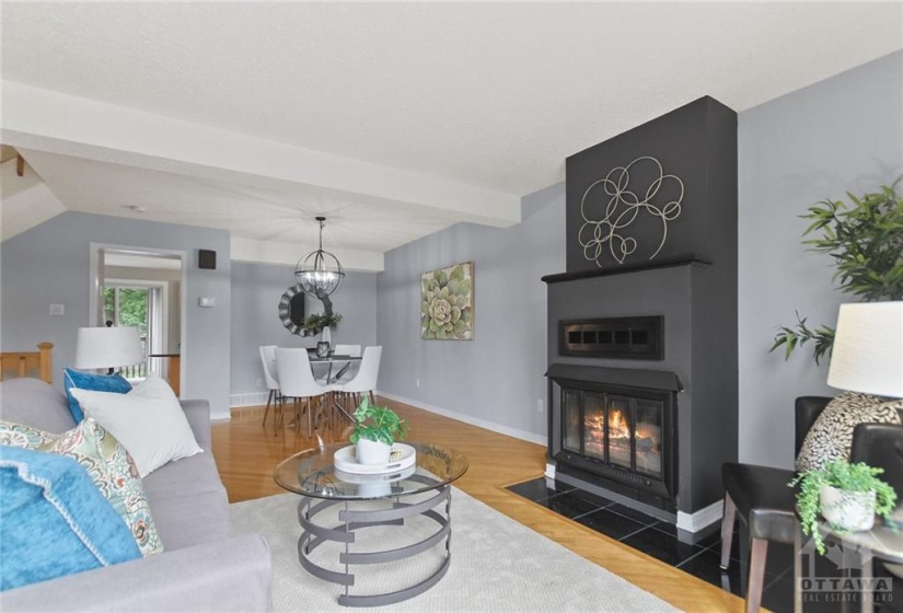 The living room is highlighted by the handsome wood-burning fireplace.