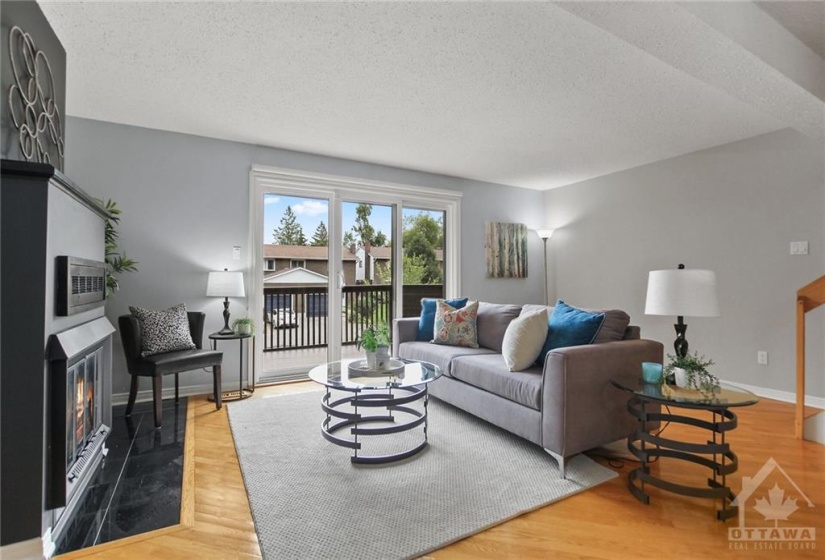 Living Room open to Dining room, and front balcony, extending your living spaces to fresh air and lush mature community.